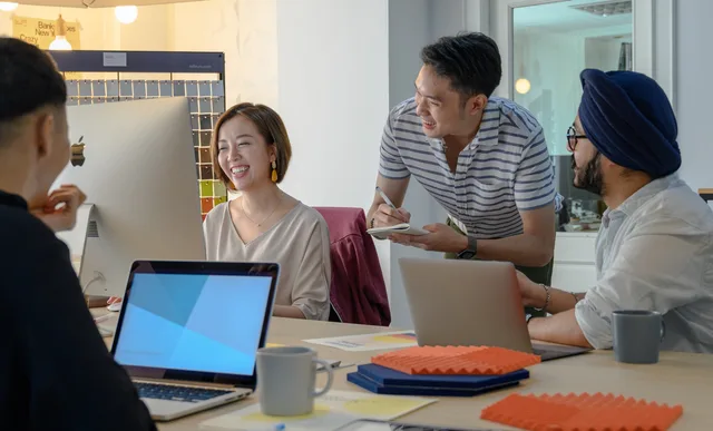 A diverse team collaborating and brainstorming in a modern office setting. Business productivity software selection checklist and record